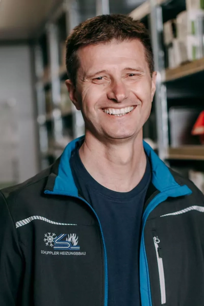 Foto eines Mitarbeiters, der in die Kamera lächelt