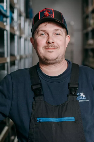 Foto eines Mitarbeiters, der in die Kamera lächelt